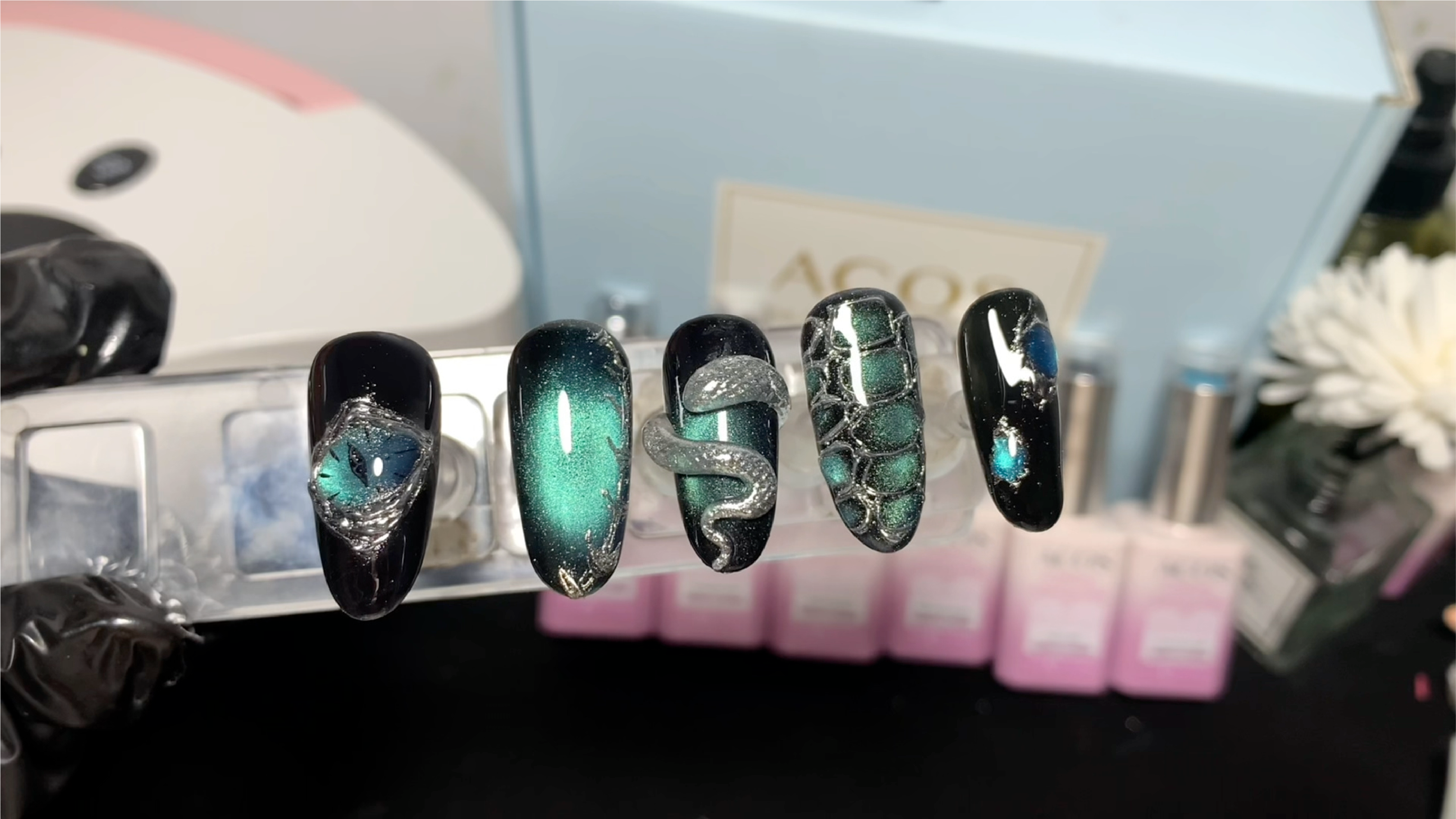 Bold emerald at eye look with magnetic light effects, snake-inspired detailing and textured scale are.