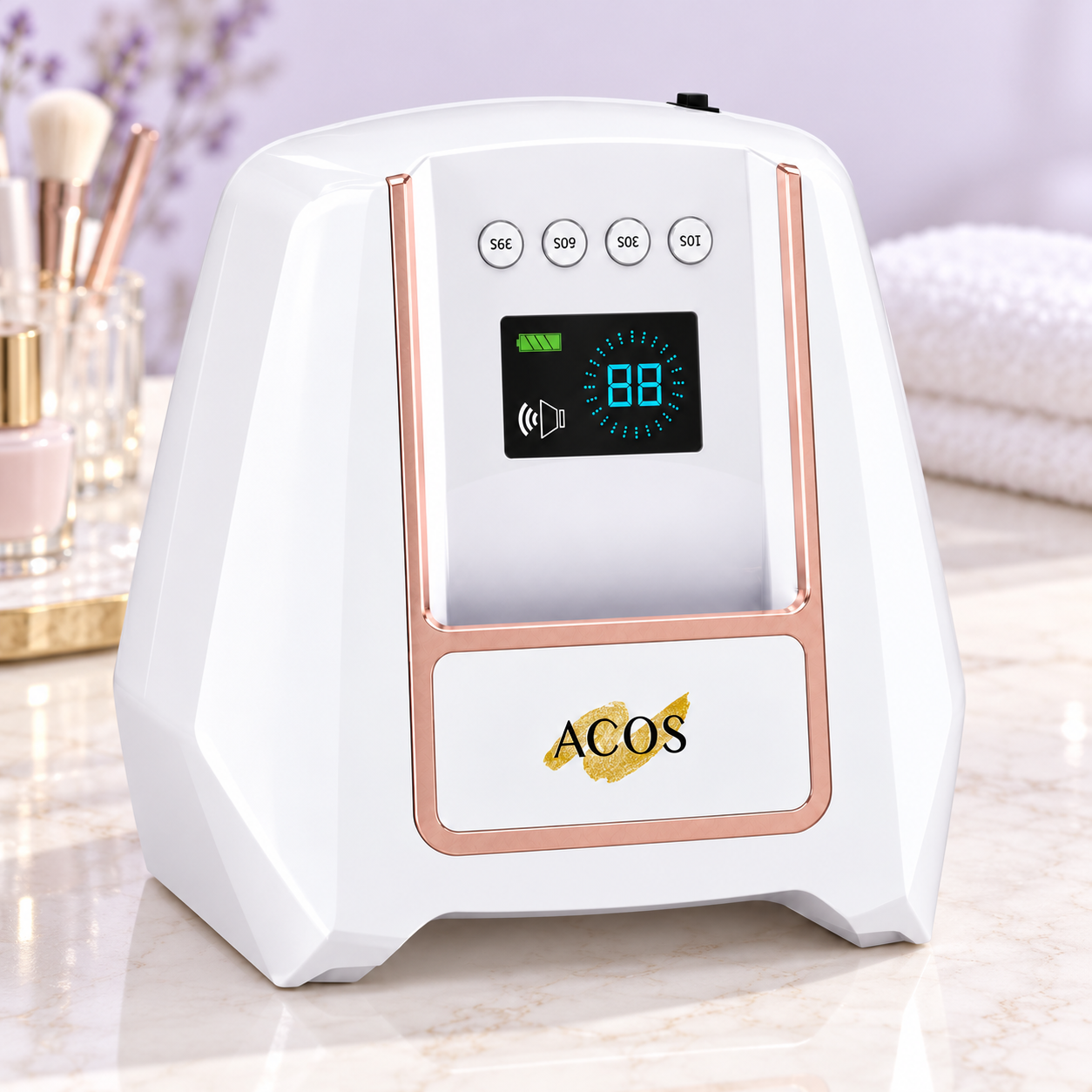 A white and rose gold ACOS beauty device with a digital display screen, set on a marble countertop with a blurred background of cosmetics and towels.